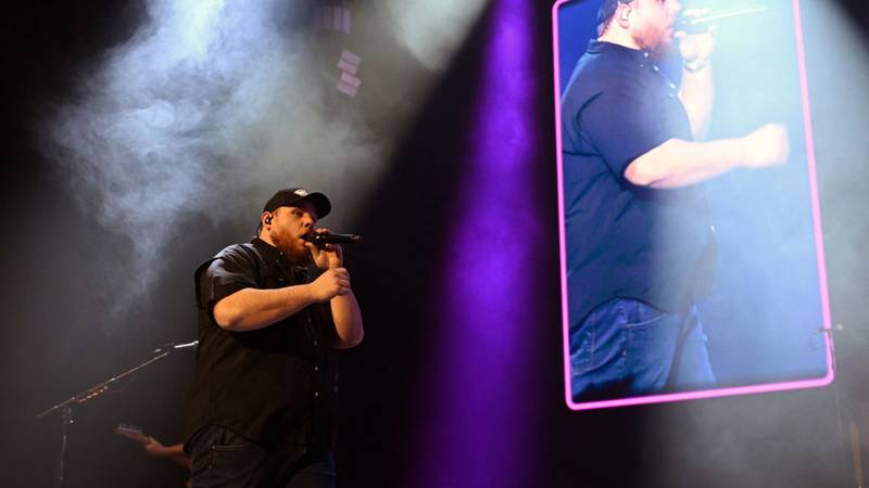 Luke Combs performing on stage.