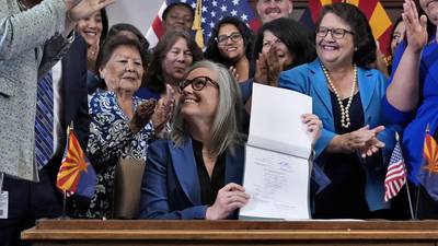 Arizona's Democratic governor signs a bill to repeal 1864 ban on most abortions