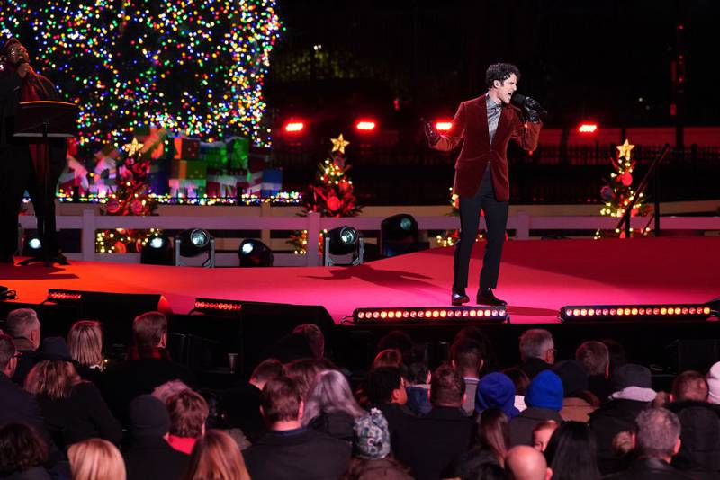 WASHINGTON, DC - NOVEMBER 30: Darren Criss performs "The Christmas Song" during the Lighting Ceremony of the National Christmas Tree in President's Park in the Ellipse of the White House on November 30, 2023 in Washington, DC. High winds toppled the tree on Tuesday but workers were able to right the 40-foot Norway spruce, which was planted just two weeks ago to replace another tree, planted in 2021, that had developed a fungal disease. (Photo by Nathan Howard/Getty Images)